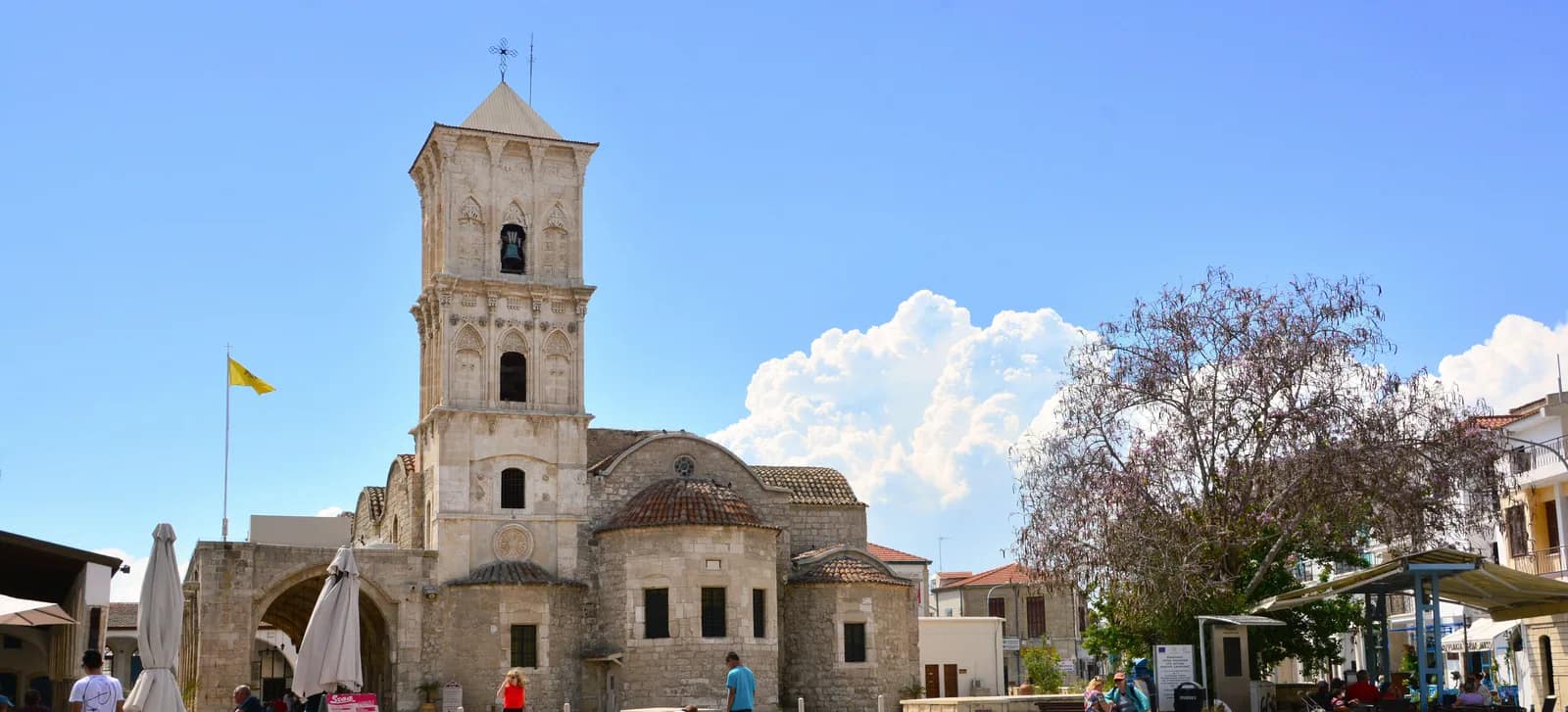 Stone bell tower and domes of the Church of Saint Lazarus in Larnaca on a sunny day