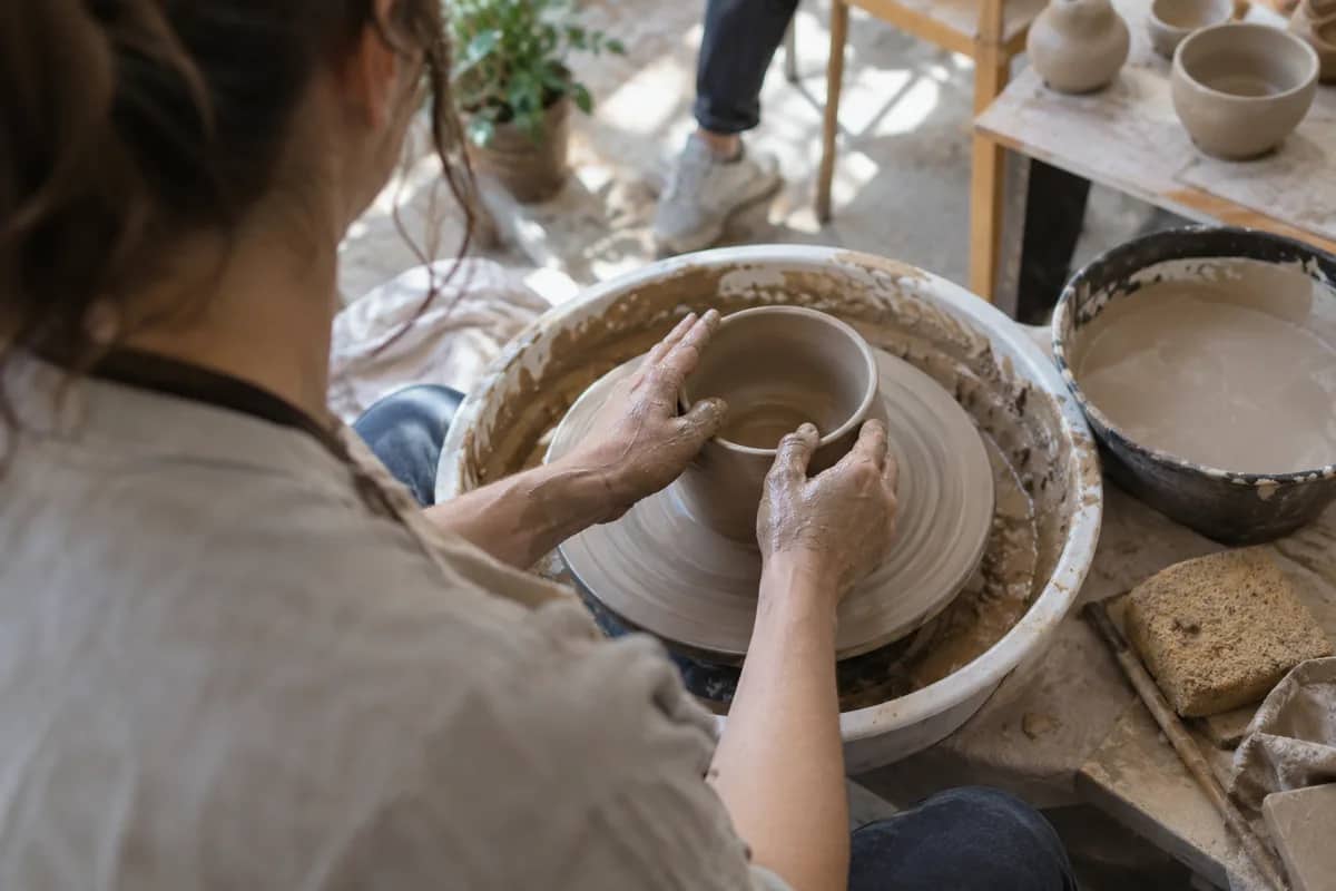 AI-generated illustration Hands shaping clay on a pottery wheel — AI-generated illustration