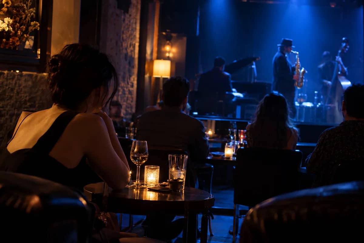 AI-generated illustration Jazz musicians on a blue-lit stage seen from a table in a club — AI-generated illustration