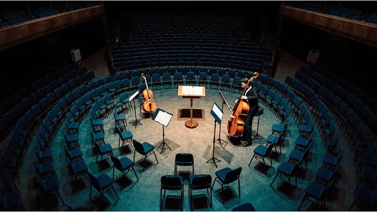 AI-generated illustration Orchestra chairs, music stands and string instruments on an empty stage — AI-generated illustration